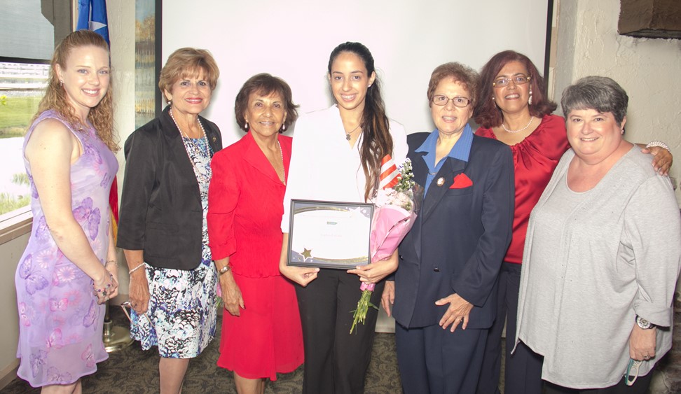 Sophia holding the scholarship award with the scholarship committee and her high school teachers